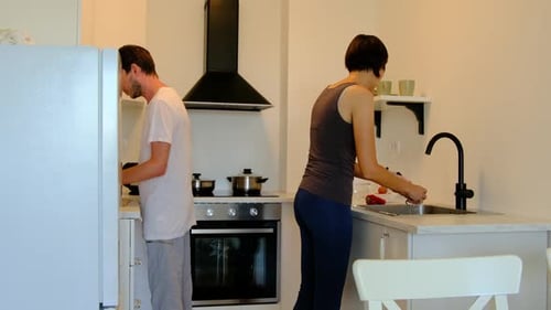 Couple Preparing Food in Bright Modern Kitchen