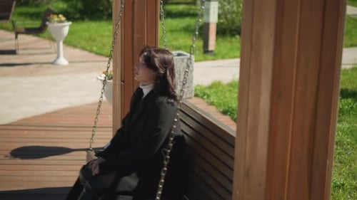 Serene Moment Woman on Swing with Hair Gently Blowing