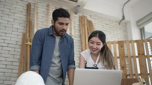Team Working on a Laptop in Workshop