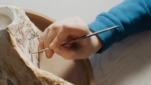 The Process of Painting a Stone in an Art Studio