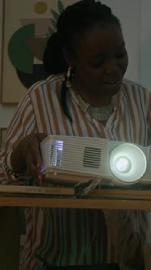 Woman and Son Using Audiovisual Projector for Home Cinema