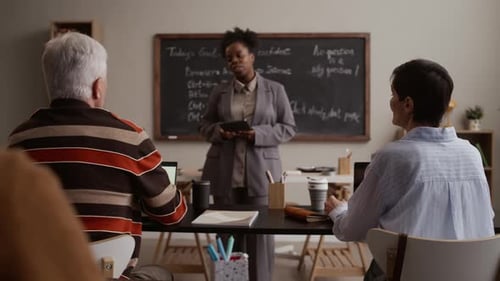 Teacher Leads Class of Adults in Classroom Setting