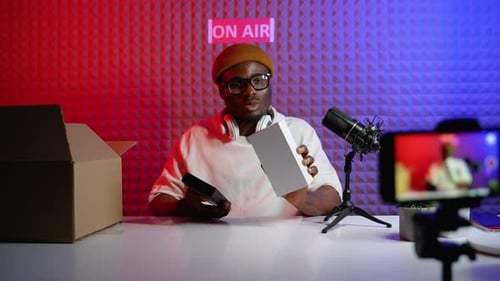Man Unboxing Products Recording a Livestream in Studio