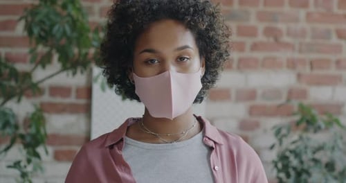 Portrait of African American Woman Wearing Medical Face Mask Standing in Loft Office During Epidemic