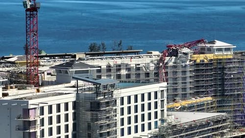 Aerial View of Ruined By Hurricane Ian Construction Crane on High Apartment Building Site in Port