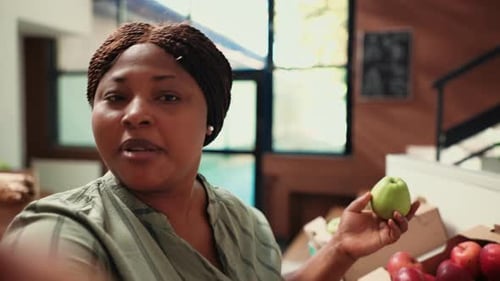 Woman Displays Food To Camera in Close Up