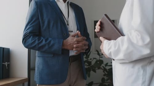 Diverse Male Hospital Executive and Doctor Shaking Hands after Meeting
