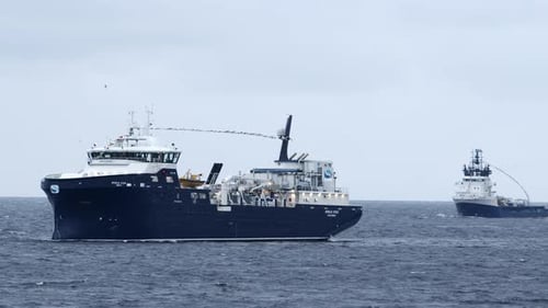 Shot of two fish farming vessels moving into dock. Shot near Stornoway on the Isle of Lewis, part of