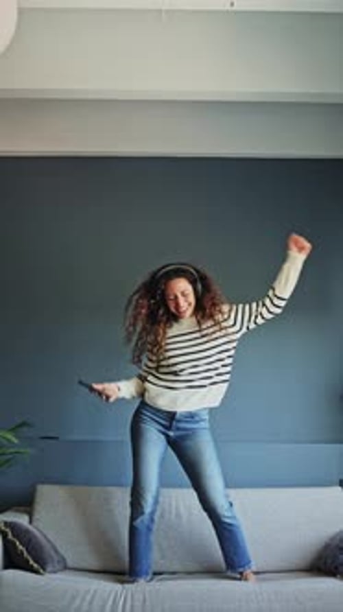 Woman Dancing on Couch at Home