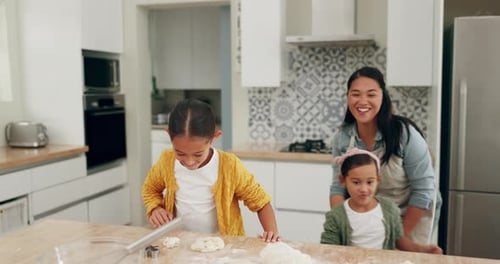 Woman and Children Baking Dough in Bright Kitchen