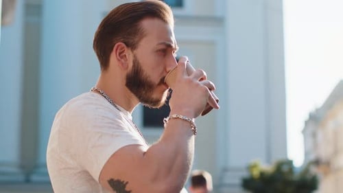 Young Man Guy Enjoying Drinking Morning Coffee Hot Drink Relaxing Taking a Break in City Street
