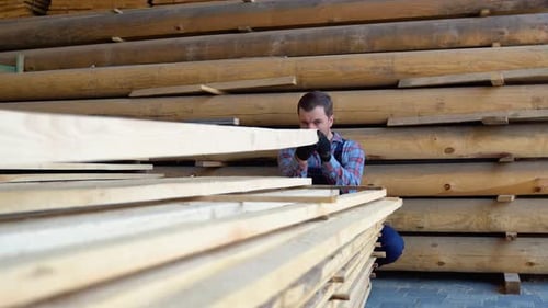 Builder Folds Wooden Planks Concept Sale of Lumber Builder is Considering Wood Planks Concept Wood