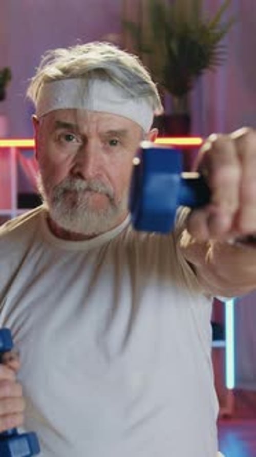 Senior Man Exercising with Dumbbells in Living Room
