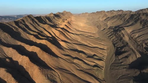 Aerial Drone View Flying Over Mountains in the Desert at Sunset