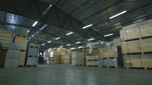 Forklift Driving through the Warehouse filled with Wood
