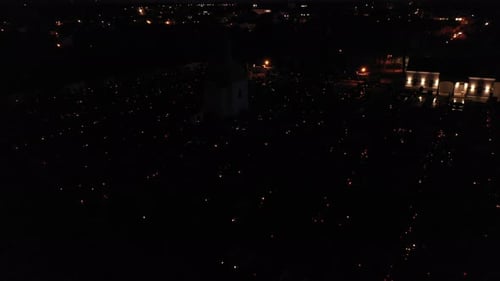 Aerial Over Graveyard At Night With Candlelights In The Dark.