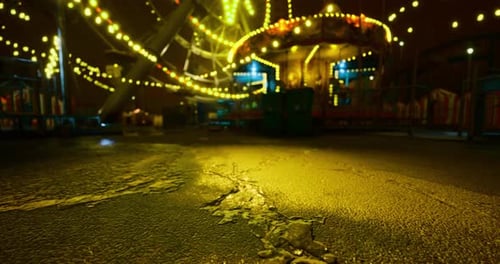 Nighttime Carnival Lights Illuminate Deserted Fairground Rides and Paths