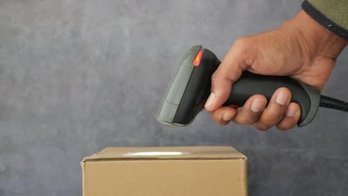 Scanning a Box with Barcode Reader in Hand