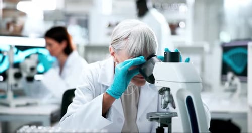 Senior Scientist Using Microscope in Modern Laboratory