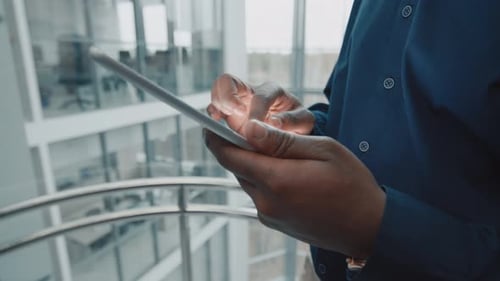 Man Using Tablet in Modern Office Setting