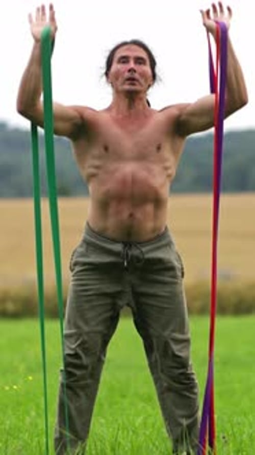 Engaging in Dynamic Outdoor Strength Training Utilizing Resistance Bands for Robust Fitness Results