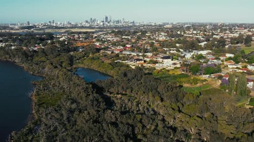 Malerischer Blick auf die urbane Skyline mit Bäumen und Wasserläufen in einem pulsierenden Küstenvorort