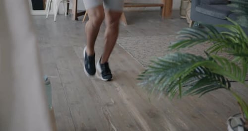 Athletic Man Performing High Knees Exercise Indoors