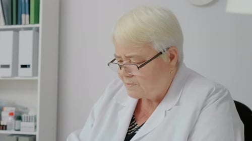 Senior Doctor Working in Medical Clinic