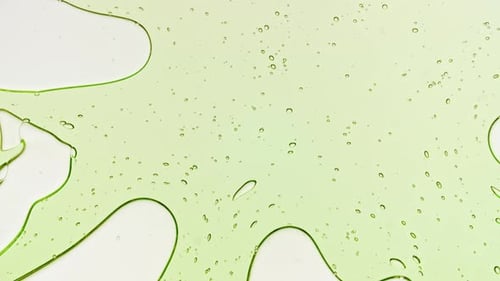 Transparent Light Green Liquid with Bubbles Spreads