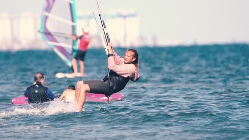 Sportsman practicing kite surf sport at the beach on a windy day at the Spanish coasts