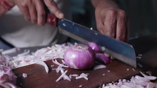 Close-up of man hand chopping onion faster.