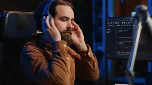 Smiling Developer Listening Music While Doing Programming Close Up