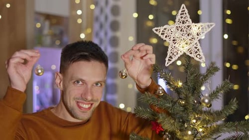 Happy Hispanic Man Hitting Small Glass Balls Together Like Clinking Glasses