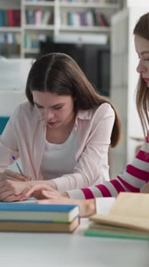 Students Work Upon Presentation in Library