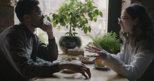 Happy Young Couple Drinking Coffee and Chatting Relaxing in Cafe Enjoying Romantic Date