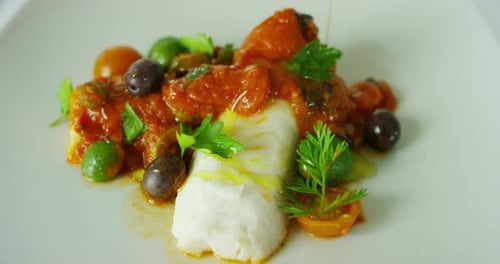 Delicious White Fish Plated with Vegetables and Sauce