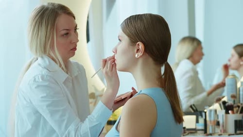 Makeup Artist Work in Her Beauty Studio Portrait of Woman Applying By Professional Make Up Master