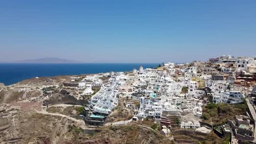 Revealing drone shot of the city Oia on the Greek island of Santorini