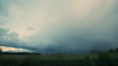 Dramatic Storm Clouds Rolling Over Grassy Landscape