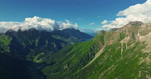 Drone Flies Over Green Picturesque Valley with Mountains in the Background High Mountains Famous