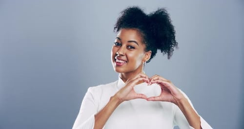 Smiling Woman Makes Heart Shape With Hands
