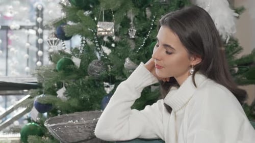 Woman Smiling in Front of Christmas Tree