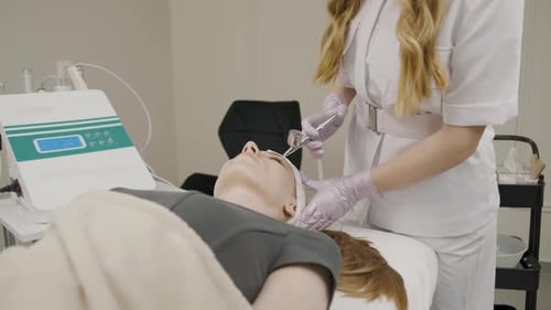 Woman Receiving Facial Cosmetic Procedure in Clinic