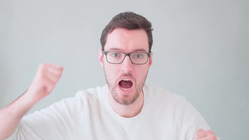 Man Gesturing and Shouting with Frustration Indoors