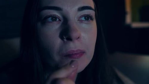 Woman Eating Potato Chips in Dark Room Close Up