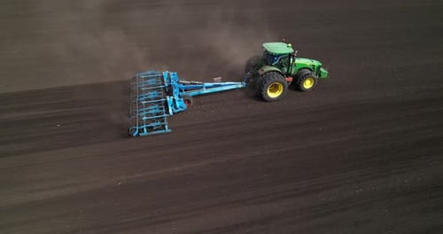 Tractor Prepares Agricultural Field for Sowing Grain Crops