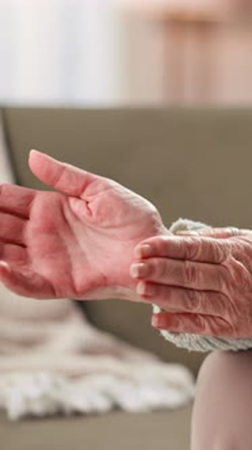 Hands, senior woman and wrist pain in home with arthritis, inflammation and carpal tunnel syndrome