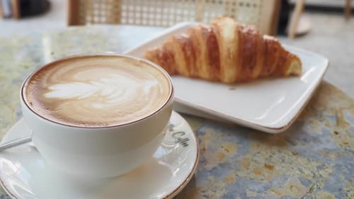 Coffee and Croissant on Wooden Table Top View