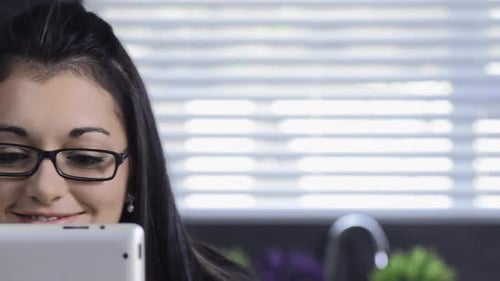 Woman with Tablet Smiling in her Home