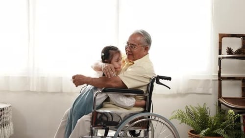 Senior Man and Grandchild Hug in Living Room